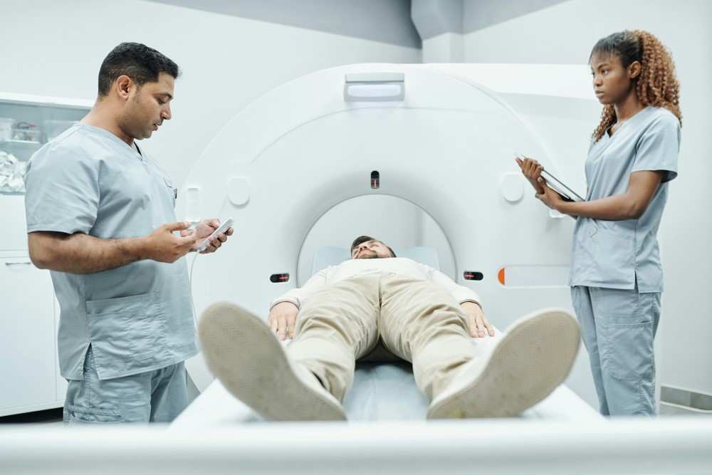 Présentation de deux soignants expliquant un examen radiologique à un patient avant gastrectomie