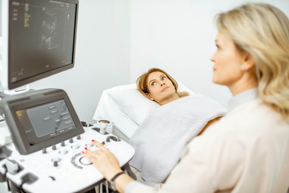 Femme pratiquant une échographie abdominale