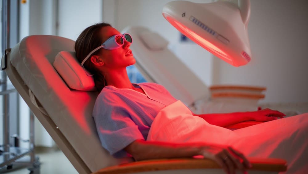 Femme sous luminothérapie cancer, lumière rouge